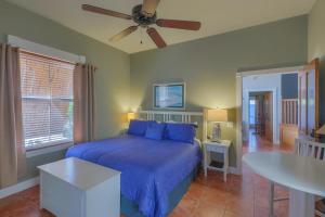 a bedroom with a bed and a ceiling fan at Cape San Blas Inn in Indian Pass