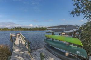 a boat sitting on a dock next to the water at Cape San Blas Inn in Indian Pass