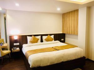 Ένα ή περισσότερα κρεβάτια σε δωμάτιο στο The Milestone Hotel