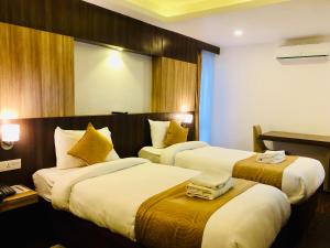 Ένα ή περισσότερα κρεβάτια σε δωμάτιο στο The Milestone Hotel