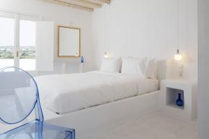 A bed or beds in a room at Aether Boutique Stay