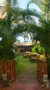 an archway with a picnic table and a palm tree at The Garden in Thong Sala