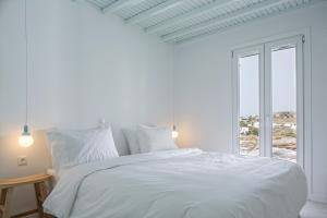 A bed or beds in a room at Aether Boutique Stay