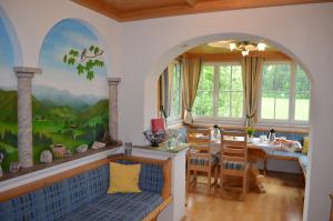 a dining room with a table and chairs at "Hochegg" in Faistenau