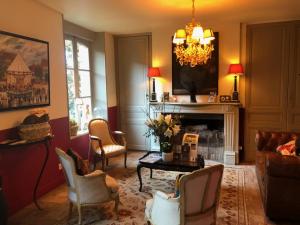 a living room with a couch and a fireplace at La Cour Sainte Catherine demeure de charme in Honfleur