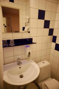 a bathroom with a sink and a toilet at Hotell Zlafen Bed and Breakfast in Karlskoga +39 photos