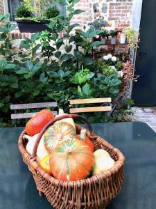 a basket filled with pumpkins sitting on a table at La Cour Sainte Catherine demeure de charme in Honfleur