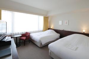 Ένα ή περισσότερα κρεβάτια σε δωμάτιο στο Hotel Garden Square Shizuoka