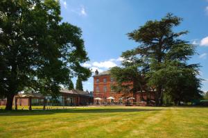 a large grassy field in front of a red brick building at Winstanley House in Leicester