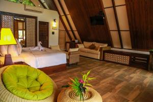 a bedroom with a bed and a living room at Liyya Water Villas in Dambulla +37 photos