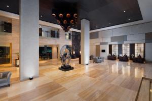 a lobby with a sculpture in the center of a building at Hotel Santika Mataram in Mataram