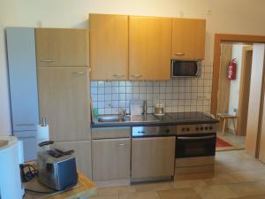 A kitchen or kitchenette at Ferienwohnungen Fritz