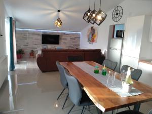 a kitchen and living room with a wooden table and chairs at Villa Jadranka Pakostane in Pakoštane