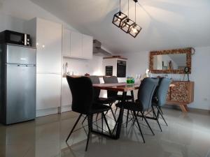 a kitchen with a table and chairs and a refrigerator at Villa Jadranka Pakostane in Pakoštane