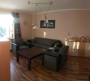 a living room with a couch and a table at Ferienwohnung Charlett in Dresden