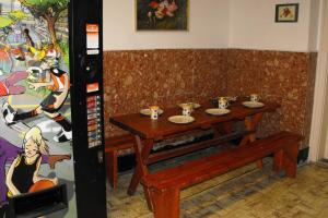 a video game booth with a table and a drink dispenser at Season Hostel 2 in Budapest