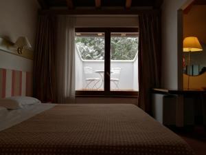 Posteľ alebo postele v izbe v ubytovaní Eurohotel Palace Maniago