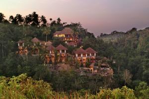 a large house on a hill in the forest at Anahata Villas and Spa Resort in Ubud