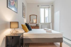 a bedroom with a large bed and a mirror at Casa Fellini - Charme Homes in Rome