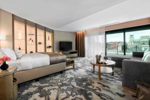 a hotel room with a large bed and a couch at InterContinental Sofia by IHG in Sofia