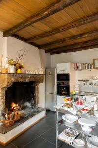 a kitchen with a fireplace with dishes on a table at Residenza Farnese in Farnese