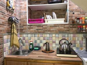a kitchen sink with two tea pots on a counter at Cliff House Gran Canaria in Gáldar +56 photos