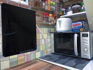 a microwave oven with a coffee maker on top of it at Cliff House Gran Canaria in Gáldar