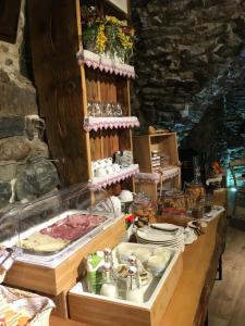 a buffet with meat and other food on a table at NicoMat Rooms in Domodossola