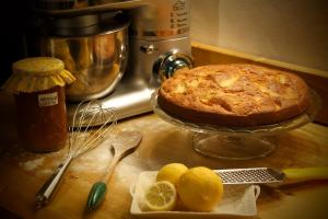 a table with a cake and lemons on a counter at Shauri Glamping in Noto