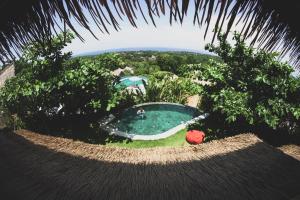 an overhead view of a swimming pool in a garden at Le Bamboo Bali in Uluwatu