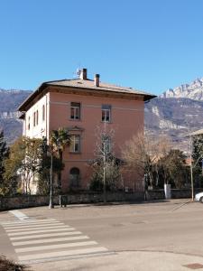 a building on a street with a mountain in the background at Ca' antica in Rovereto