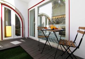 a balcony with a table and chairs on it at HM - The Garden in Porto