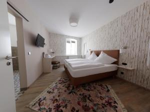 a bedroom with a bed and a rug at Hotel - Weinbar FAHR AWAY in Volkach
