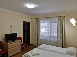 Ένα ή περισσότερα κρεβάτια σε δωμάτιο στο Fantanita Craiesei