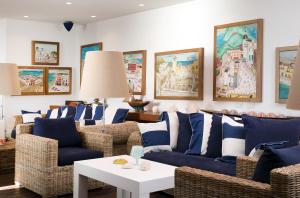 a living room filled with furniture and a painting on the wall at Capo la Gala Hotel&Wellness in Vico Equense