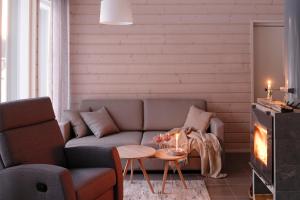 a living room with a couch and a table at WOODDREAM in Taipalsaari