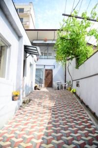 a brick walkway with a tree in the middle of a building at Hotel New Avlabari in Tbilisi City