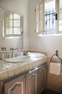 a bathroom with a sink and a window at Maison Le Retour in Le Rouret