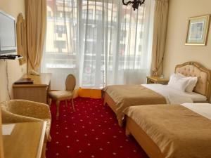 Postel nebo postele na pokoji v ubytování Visak Hotel