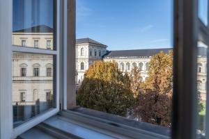 Hotel-Pension am Siegestor في ميونخ: نافذة مفتوحة مطلة على مبنى