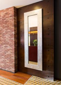 a brick wall with a window and a potted plant at Hospedium Hotel Posada De La Luna in Huesca