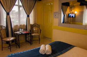 Postel nebo postele na pokoji v ubytování Kahama Hotel Nairobi