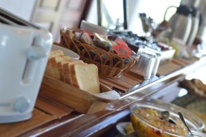 a buffet with bread and other food on a table at Hotel Hostal del Espinillo in Dolores