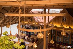 a bunch of lights hanging from a wooden ceiling at Gagauz Sofrasi in Congaz