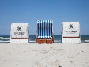 three beach chairs sitting in the sand on the beach at Beach Cloud***** in Binz