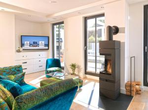 a living room with a couch and a fireplace at Beach Cloud***** in Binz
