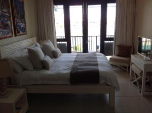 a bedroom with a large bed and a balcony at Eden Island luxury apartment sea view in Eden Island +42 photos