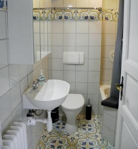 a bathroom with a white sink and a toilet at Haus Ihlkatenweg in Kiel