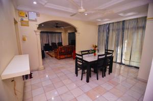 a dining room with a table and chairs at Vintage Homestay in Perai