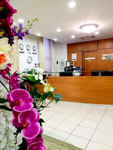a waiting area with flowers in a waiting room at Grand Plaza Serviced Apartments in London